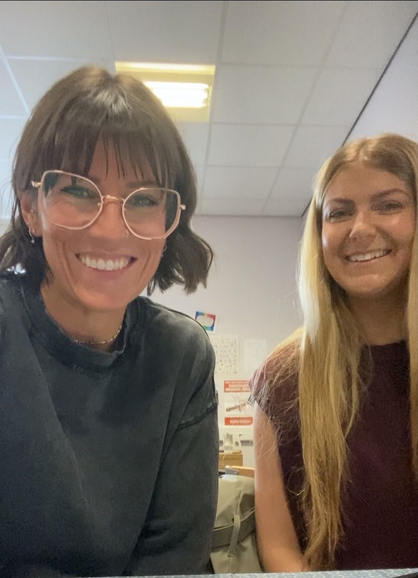 Two smiling students taking a selfie during their placement.